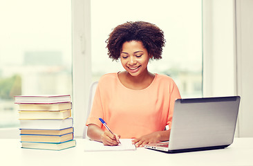 Image showing happy african american woman with laptop at home