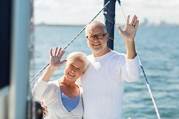 Image showing senior couple hugging on sail boat or yacht in sea