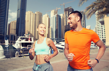 Image showing couple running over dubai city street background