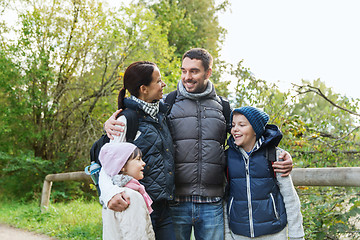 Image showing happy family with backpacks hiking