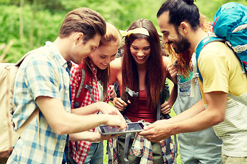 Image showing happy friends with backpacks and tablet pc hiking