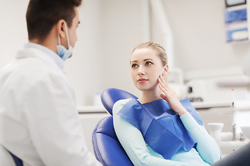 Image showing male dentist with woman patient at clinic