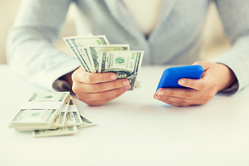 Image showing close up of woman hands with smartphone and money