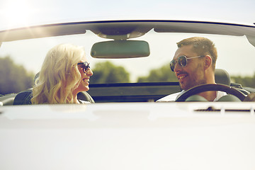 Image showing happy man and woman driving in cabriolet car