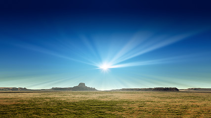 Image showing a desert scenery with sun rays in the blue sky