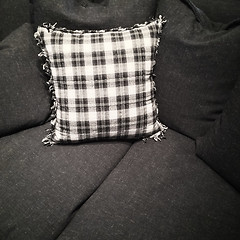 Image showing Checked cushion on a dark gray sofa