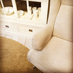 Image showing Detail of a living room with armchair and sideboard