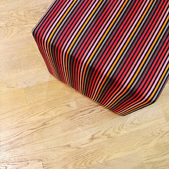 Image showing Striped cube chair on wooden floor