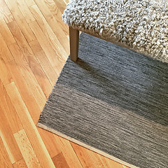 Image showing Sheepskin bench on wooden floor