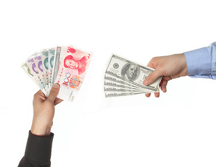 Image showing Hands holding yuan and dollar bills