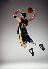 Image showing Full length portrait of a basketball player with ball