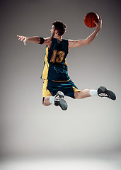 Image showing Full length portrait of a basketball player with ball