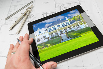 Image showing Hand of Architect on Computer Tablet Showing Home Photo Over Hou