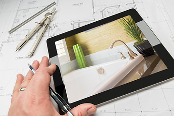 Image showing Hand of Architect on Computer Tablet Showing Bathroom Details Ov