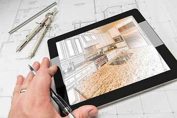 Image showing Hand of Architect on Computer Tablet Showing Kitchen Illustratio