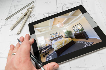 Image showing Hand of Architect on Computer Tablet Showing Bedroom Over House 