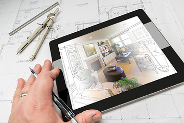 Image showing Hand of Architect on Computer Tablet Showing Living Room Over Ho