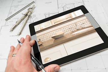 Image showing Hand of Architect on Computer Tablet Showing Bathroom Details Ov