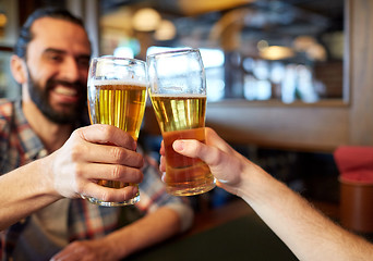 Image showing happy male friends drinking beer at bar or pub