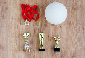 Image showing close up of volleyball ball, cups and medals