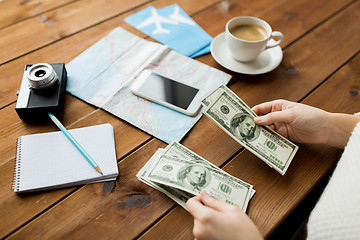 Image showing close up of traveler hands counting dollar money