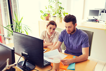 Image showing creative team with computer and papers in office