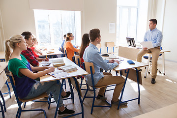 Image showing group of students and teacher with papers or tests