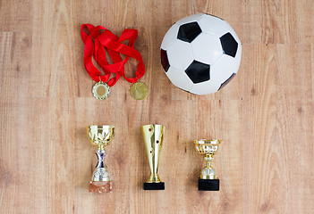 Image showing football or soccer ball, golden cups and medals