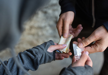 Image showing close up of addict buying dose from drug dealer