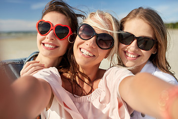 Image showing group of smiling women taking selfie on beach