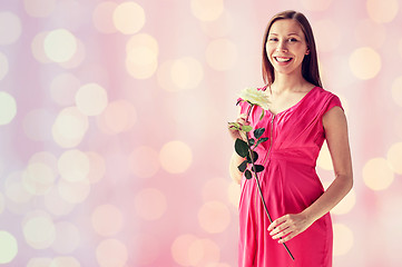 Image showing happy pregnant woman with rose flower