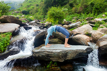 Image showing Woman doing Ashtanga Vinyasa Yoga asana Urdhva Dhanurasana - up