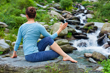 Image showing Woman doing Ardha matsyendrasana asana outdoors