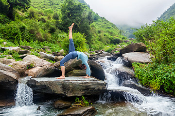 Image showing Woman doing yoga asana at waterfall