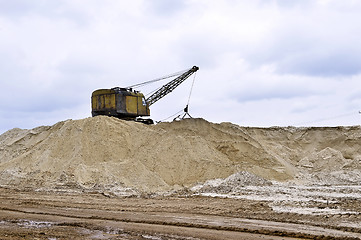 Image showing Working digger in a quarry produces sand Working digger in a quarry produces sand