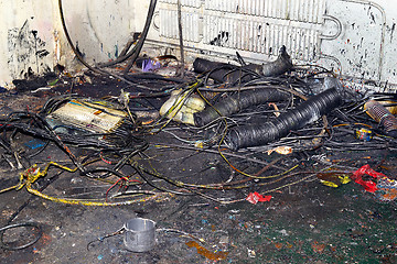 Image showing Metal waste contaminated with oil, lay on the floor in the workplace