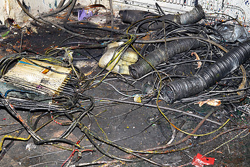 Image showing Metal waste contaminated with oil, lay on the floor in the workplace