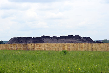 Image showing Keeping the soil in the open ground in the warehouse site with a fence