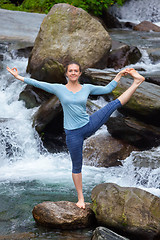 Image showing Woman doing Ashtanga Vinyasa Yoga asana outdoors at waterfall