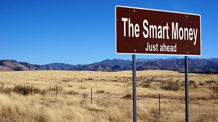 Image showing The Smart Money brown road sign