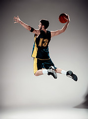 Image showing Full length portrait of a basketball player with ball