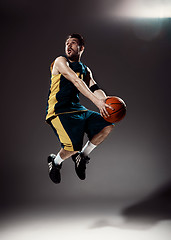 Image showing Full length portrait of a basketball player with ball