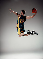 Image showing Full length portrait of a basketball player with ball