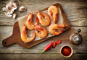 Image showing roasted prawns on wooden cutting board