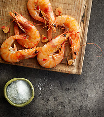 Image showing roasted prawns on wooden cutting board