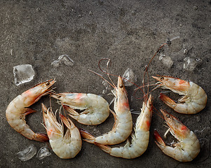 Image showing fresh raw prawns on dark gray background