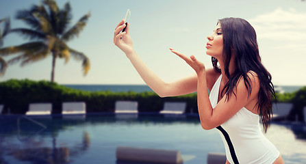 Image showing young woman taking selfie with smartphone