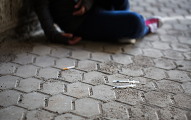 Image showing close up of addict woman and drug syringes