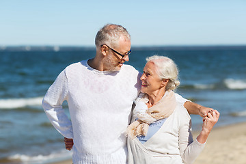 Image showing happy senior couple hugging on summer beach