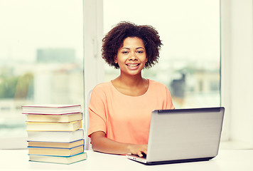 Image showing happy african american woman with laptop at home